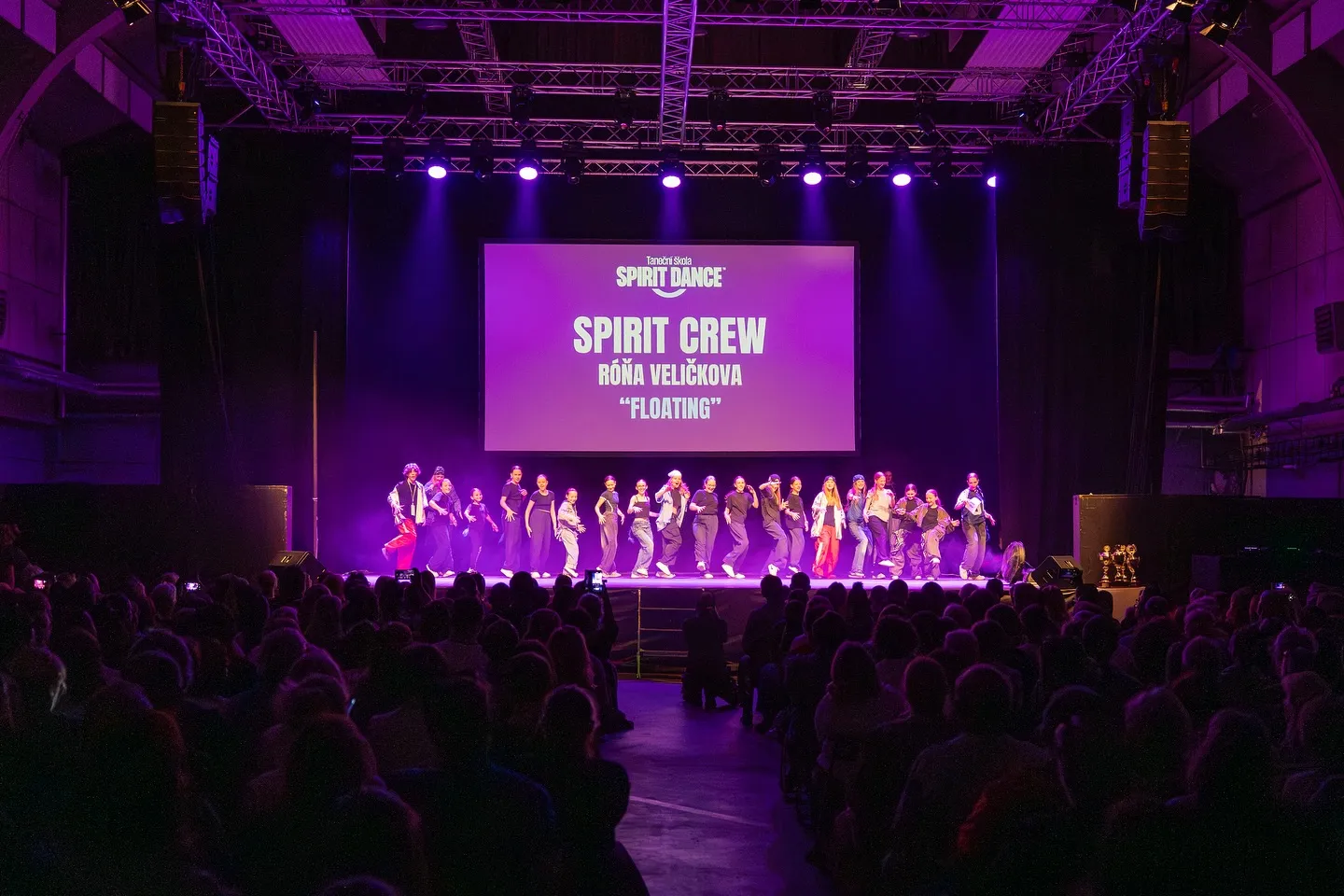 Spirit Crew na pódiu před zaplněným sálem